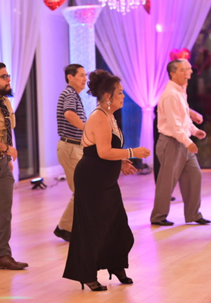Adult students lined up for a group class on the studio floor