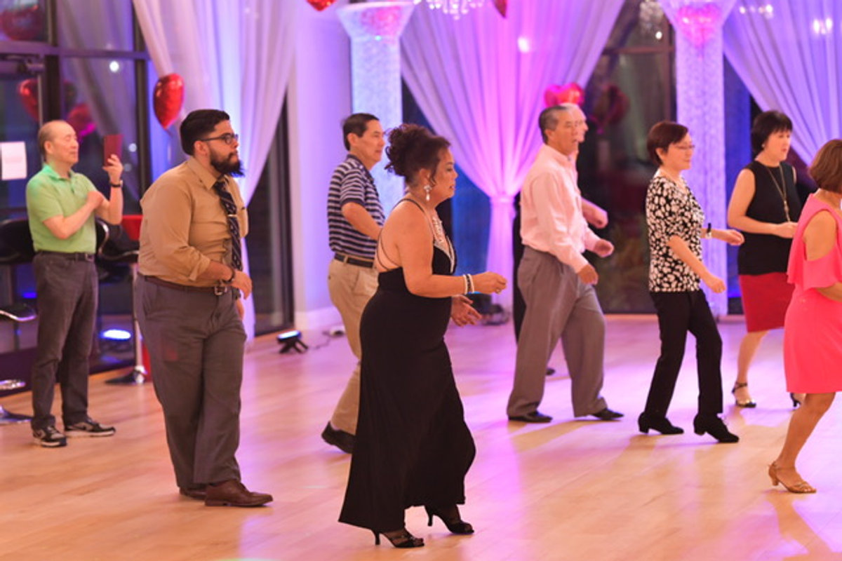 Adult students practising together in a group class at VM Ballroom Dance Studios