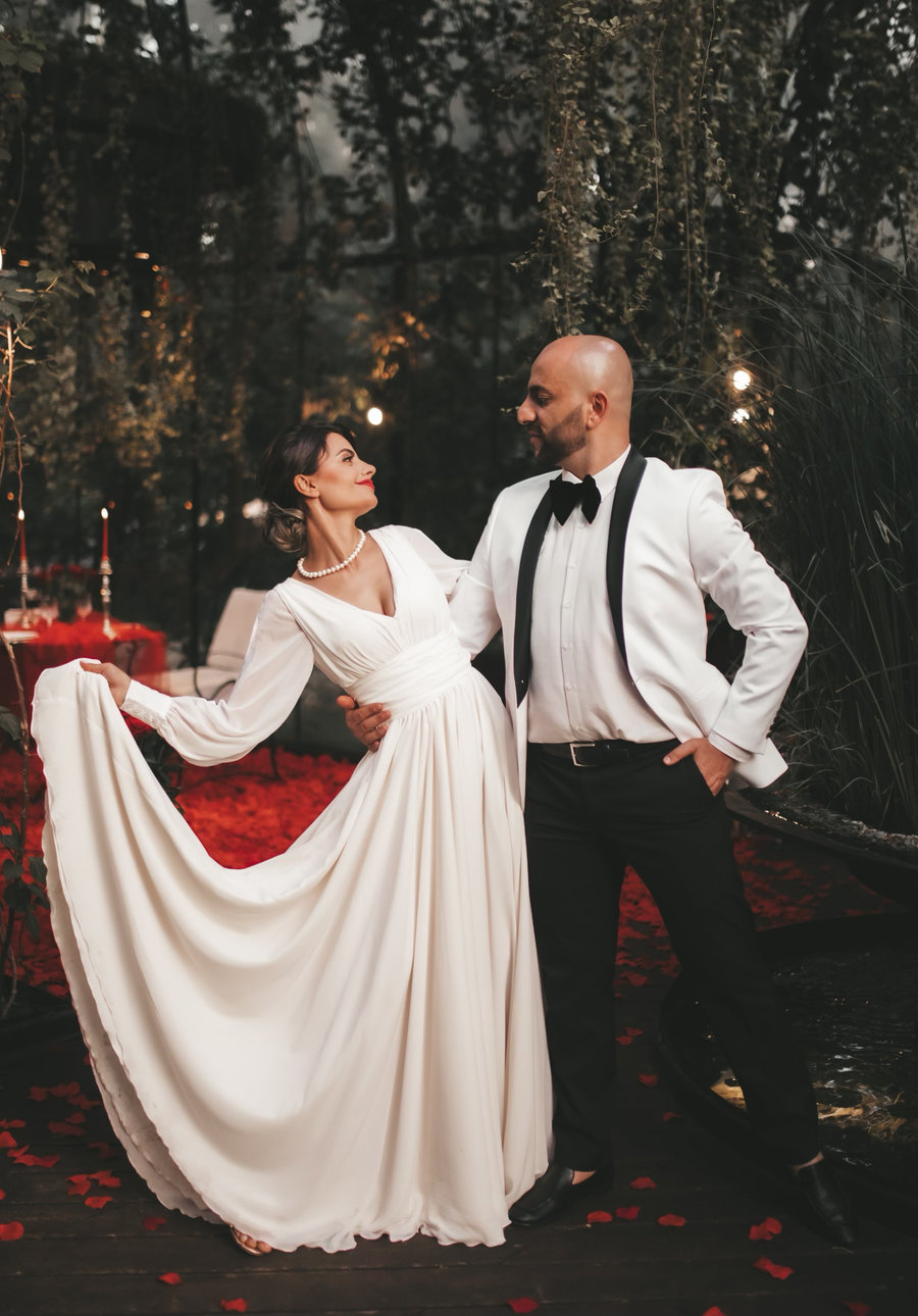 A couple in evening dress, a white dinner jacket and a full-skirted gown