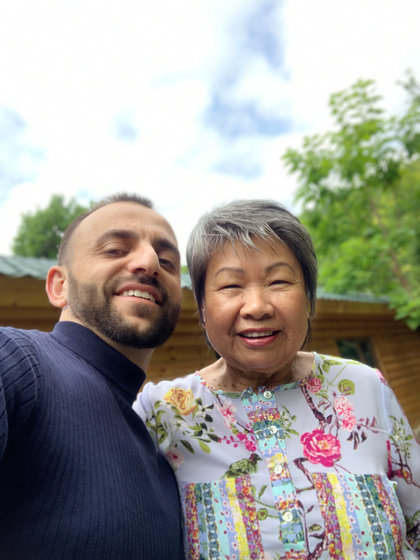 Two of the travellers together in a close photograph outdoors, both smiling