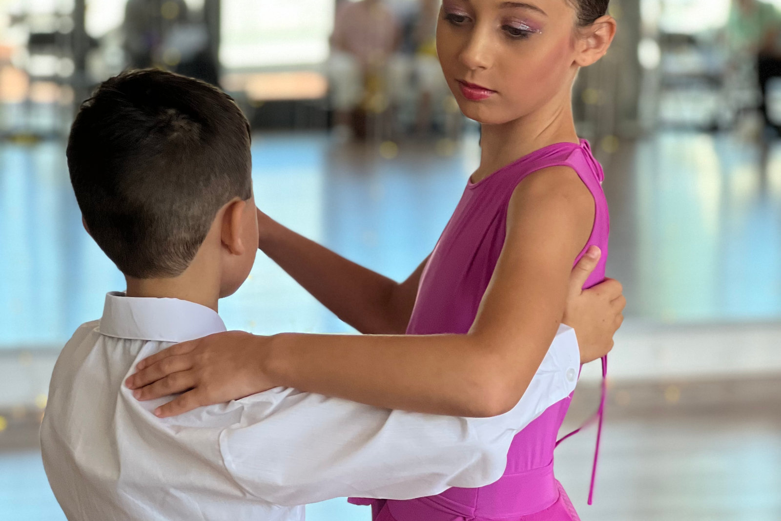 Two young dancers in ballroom hold practising together on the studio floor at VM Ballroom Dance Studios