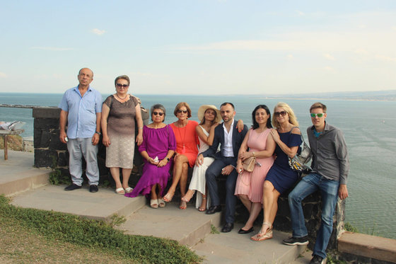 Eleven of the group, dressed for the evening, on the stone terrace above the lake