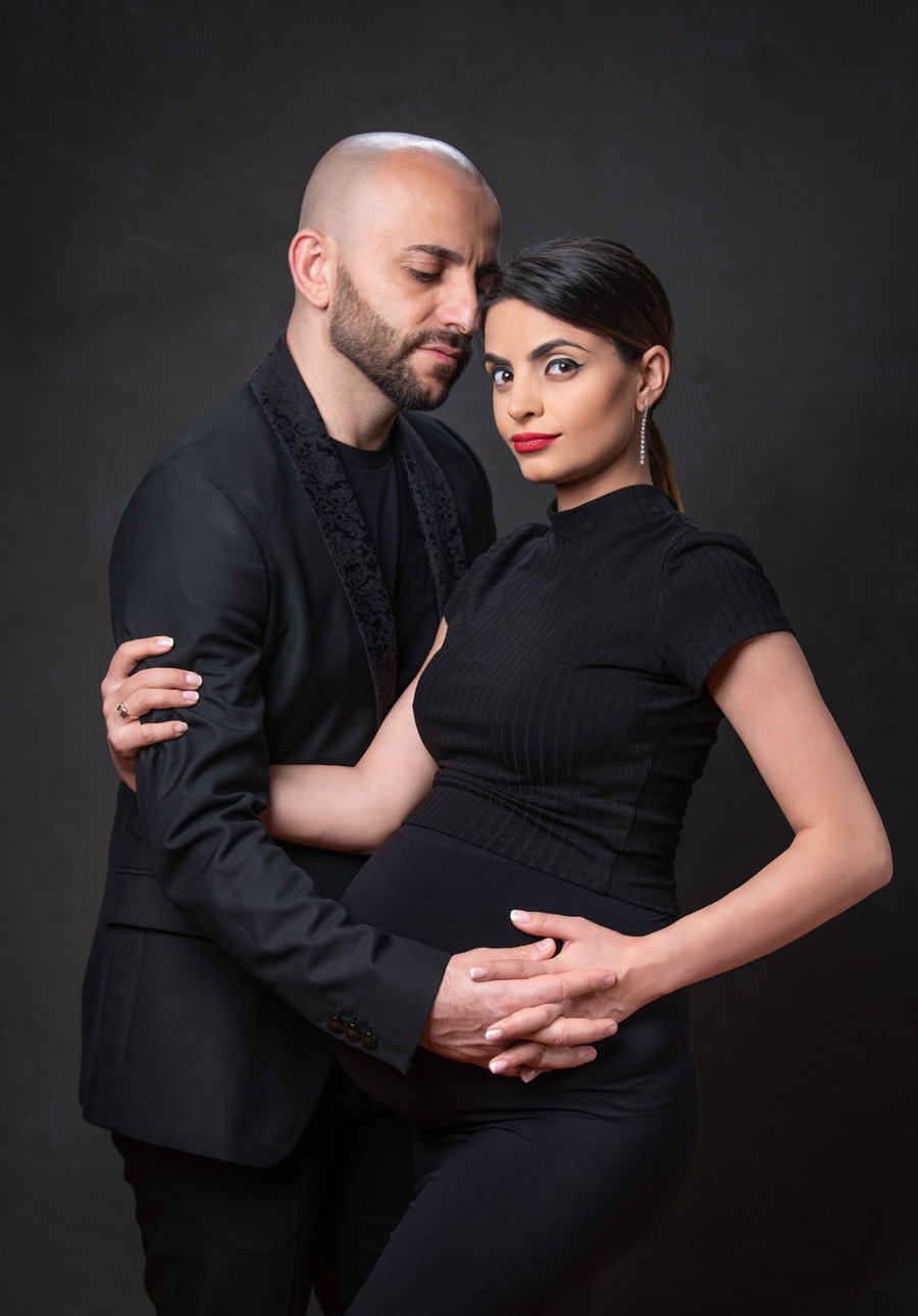 Two dancers in a close hold in a VM Ballroom Dance Studios studio portrait